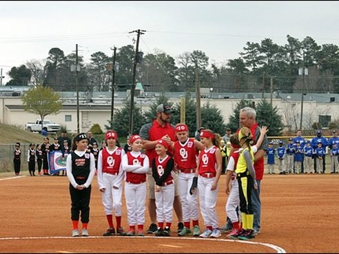 Toccoa Little League softball players lined up along the first-base line on opening day
