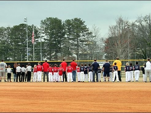 Players from every division standing along the baselines on opening day