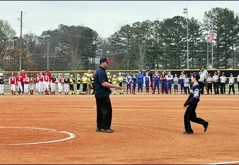 A Toccoa Little League coach and players on the infield during opening ceremonies